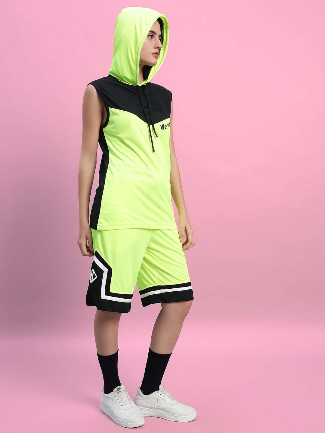 WOMEN'S FRANKY GYM CO-ORD SET NEON GREEN modeled on pink background.