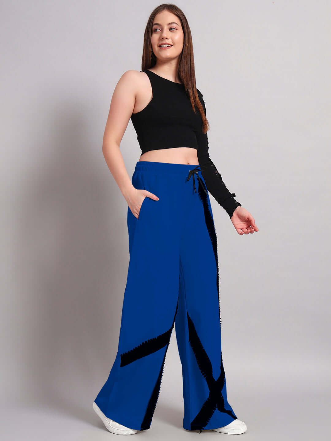 Woman wearing black and blue frayed textured stripes co-ord set with elasticated waistband and relaxed fit joggers.