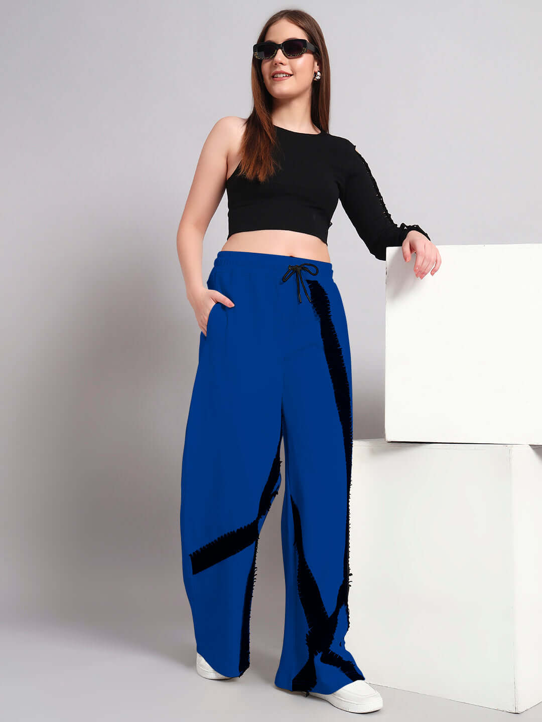 Woman wearing black and blue frayed textured stripes co-ord set with relaxed fit joggers, showcasing casual fashion style.