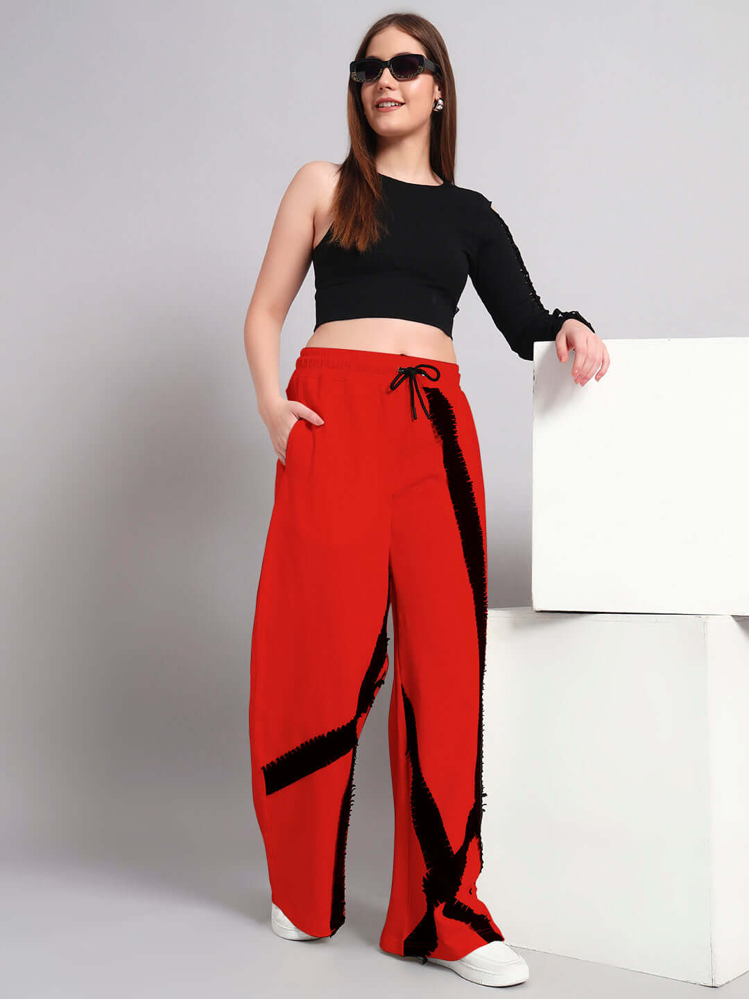 Woman wearing black and red frayed textured stripe co-ord set, featuring relaxed fit joggers with elastic waistband.