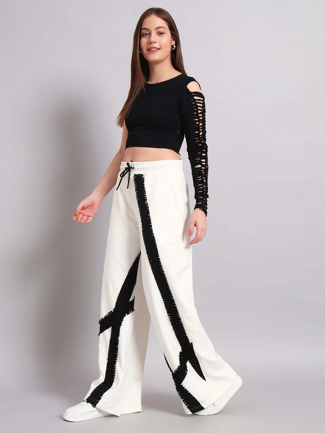 Model wearing women's frayed textured stripes co-ord set in off-white and black, featuring relaxed fit joggers with elasticated waistband.