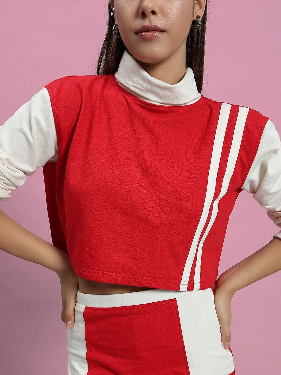 Woman wearing WOMEN FREYA CO-ORD SET OFF WHITE RED showcasing chic design against pink background.