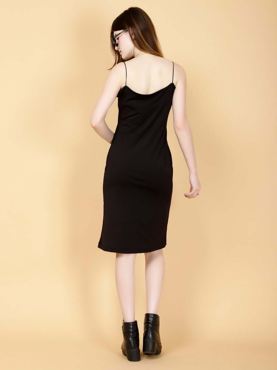 Back view of model wearing WOMEN GLAMOUR LYCRA DRESS BLACK, showcasing its elegant design and comfortable fit.