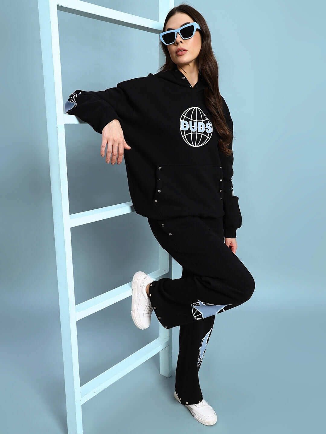 Woman wearing WOMEN GLOBAL FLEECE CO-ORD BLACK, stylish hoodie and joggers for streetwear fashion.