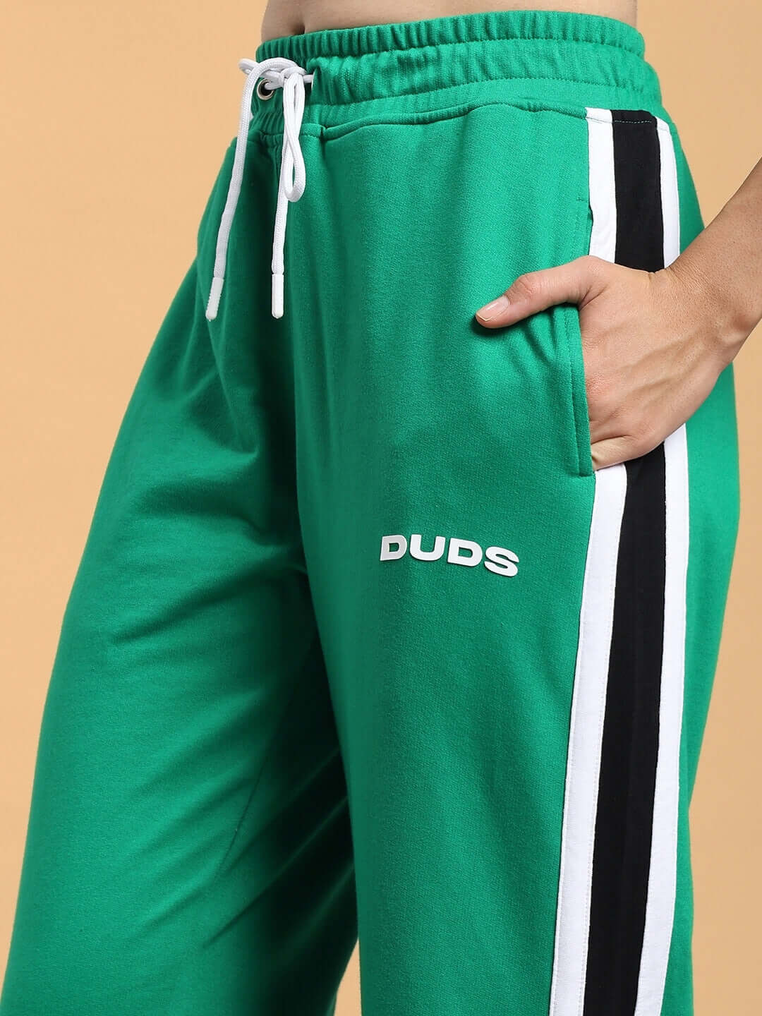 Green women's Rosston joggers by DUDS featuring relaxed fit and black side stripes.