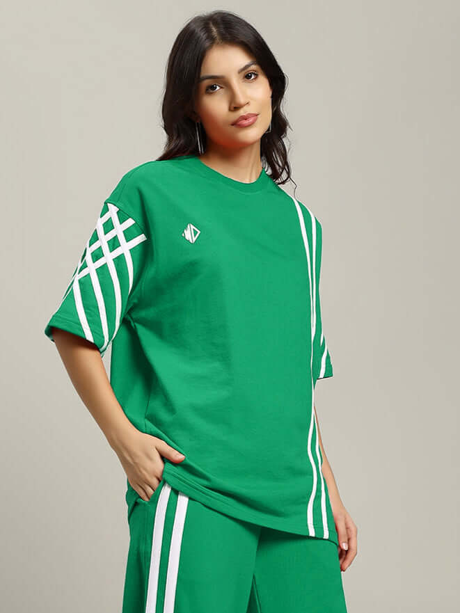 Model wearing green women's oversized striped t-shirt with premium cotton and elastane, featuring white accents, by Color By Colours.