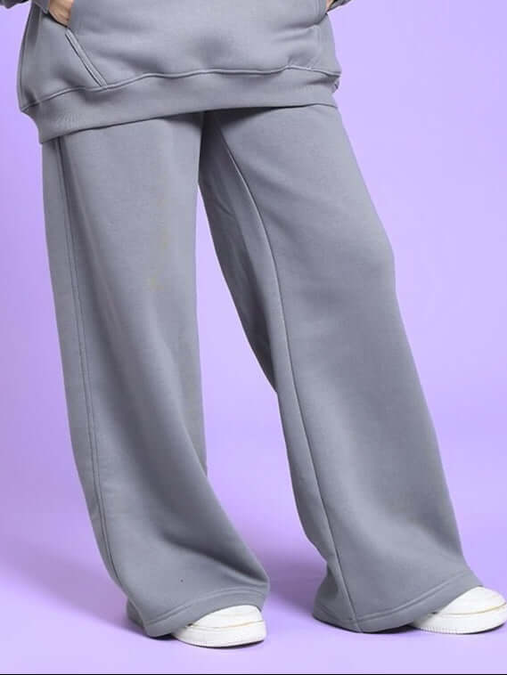 WOMEN'S MAKE IT HAPPEN COTTON FLEECE JOGGER GREY displayed on a model against a purple background.