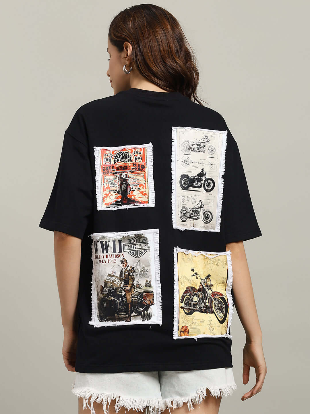 Woman wearing WOMEN'S HARLEY DESIGNER OVER-SIZED T-SHIRT BLACK with vintage motorcycle prints on the back.