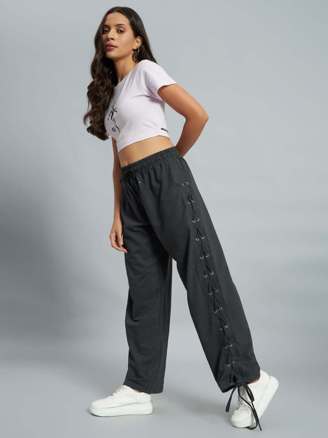 Model wearing Women's Hazel Relaxed Fit Joggers in Grey with lace-up detail, showcasing the tailored design by DUDS.