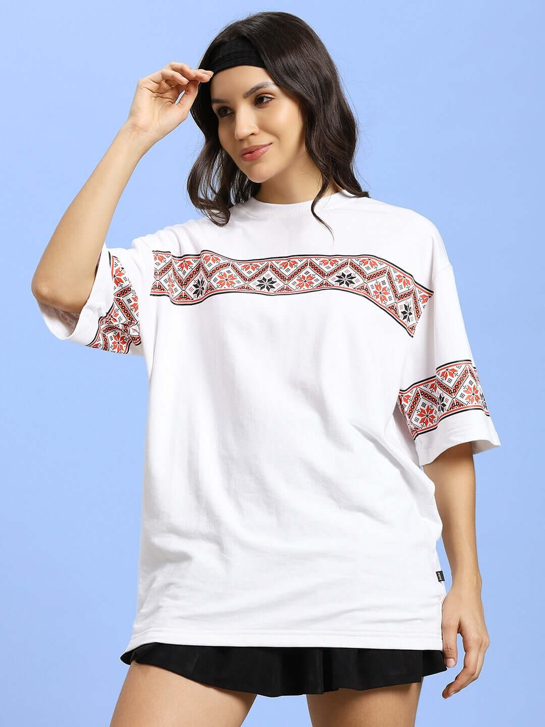 Woman wearing a white t-shirt with traditional Vyshyvanka print, made from premium cotton fabric, emphasizing comfort and style.