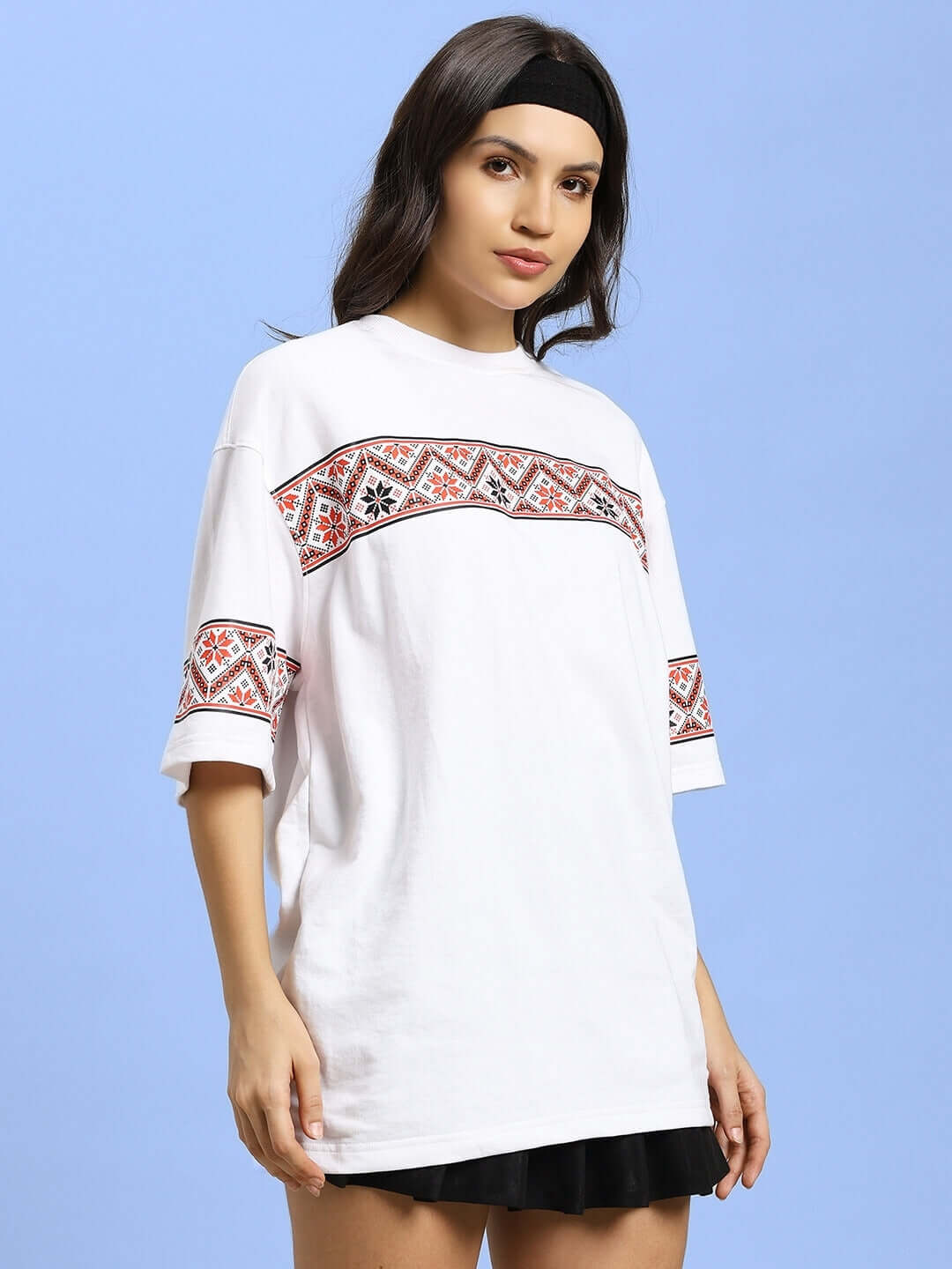 Model wearing white Vyshyvanka print t-shirt, featuring intricate red and black embroidery, crafted from premium cotton fabric.