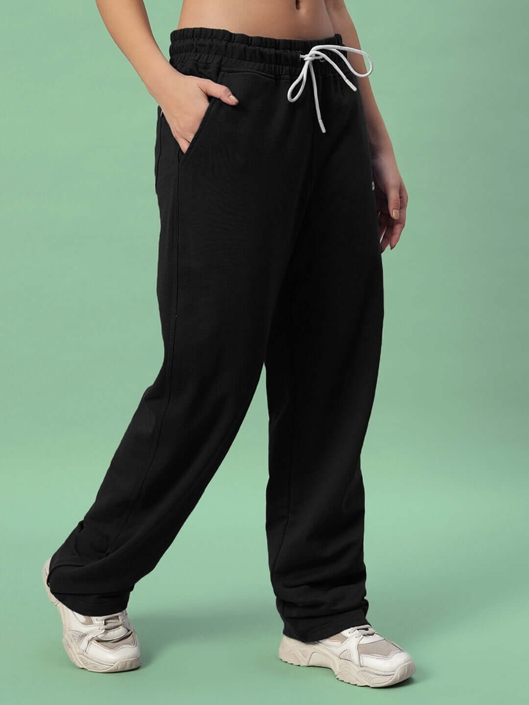 Women's black joggers with side slit, featuring customizable fit by DUDS. Ideal for casual wear and active lifestyles.