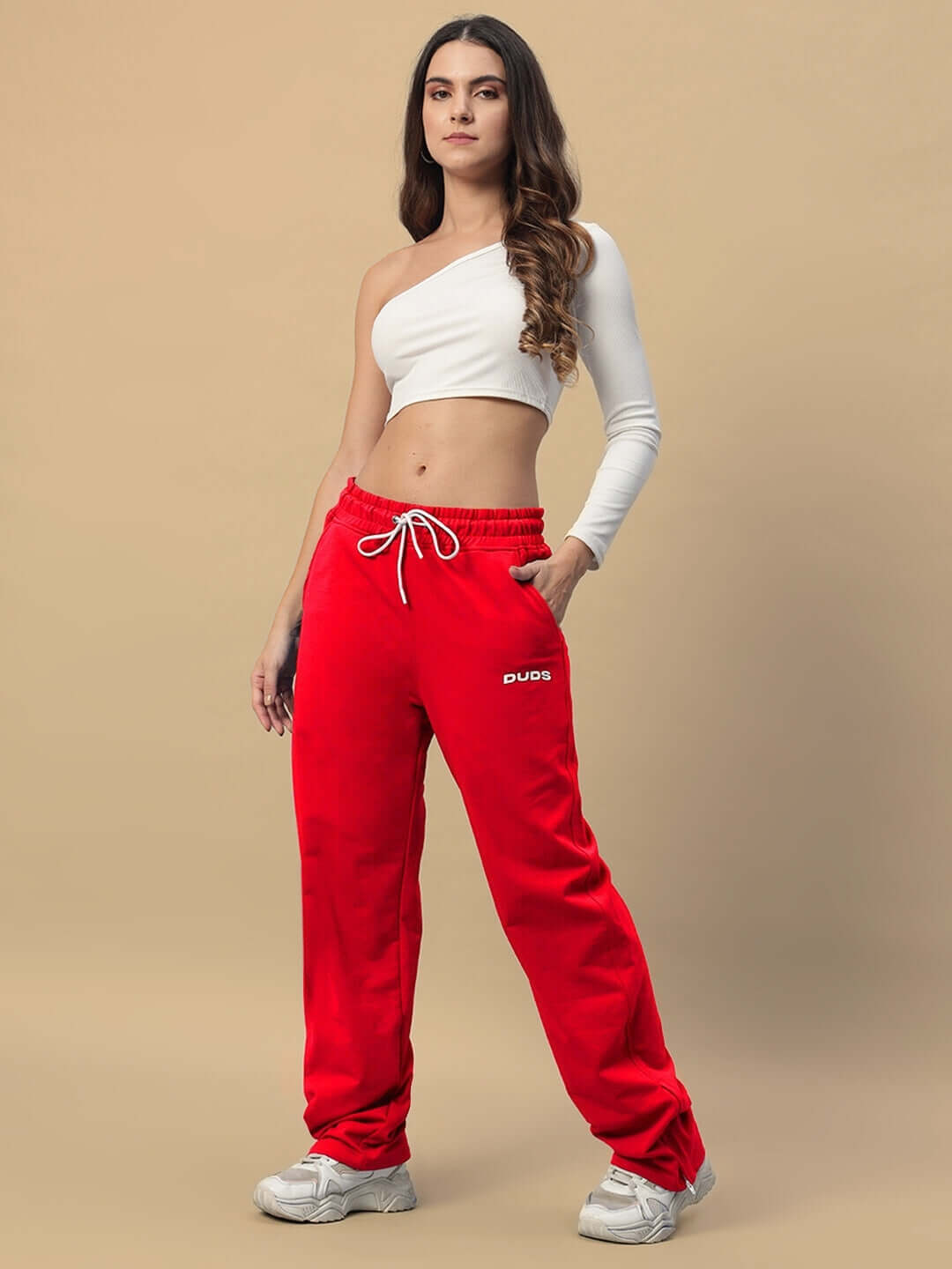 Model wearing women's red Hershey side slit joggers by DUDS, featuring a drawstring waist and comfortable fit.
