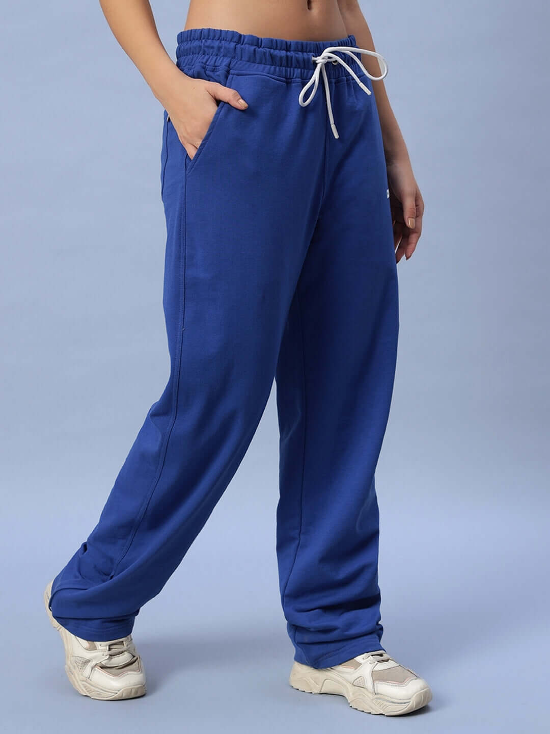 Royal blue women's joggers with side slit, featuring a relaxed fit and white drawstring; perfect for casual wear and comfort.