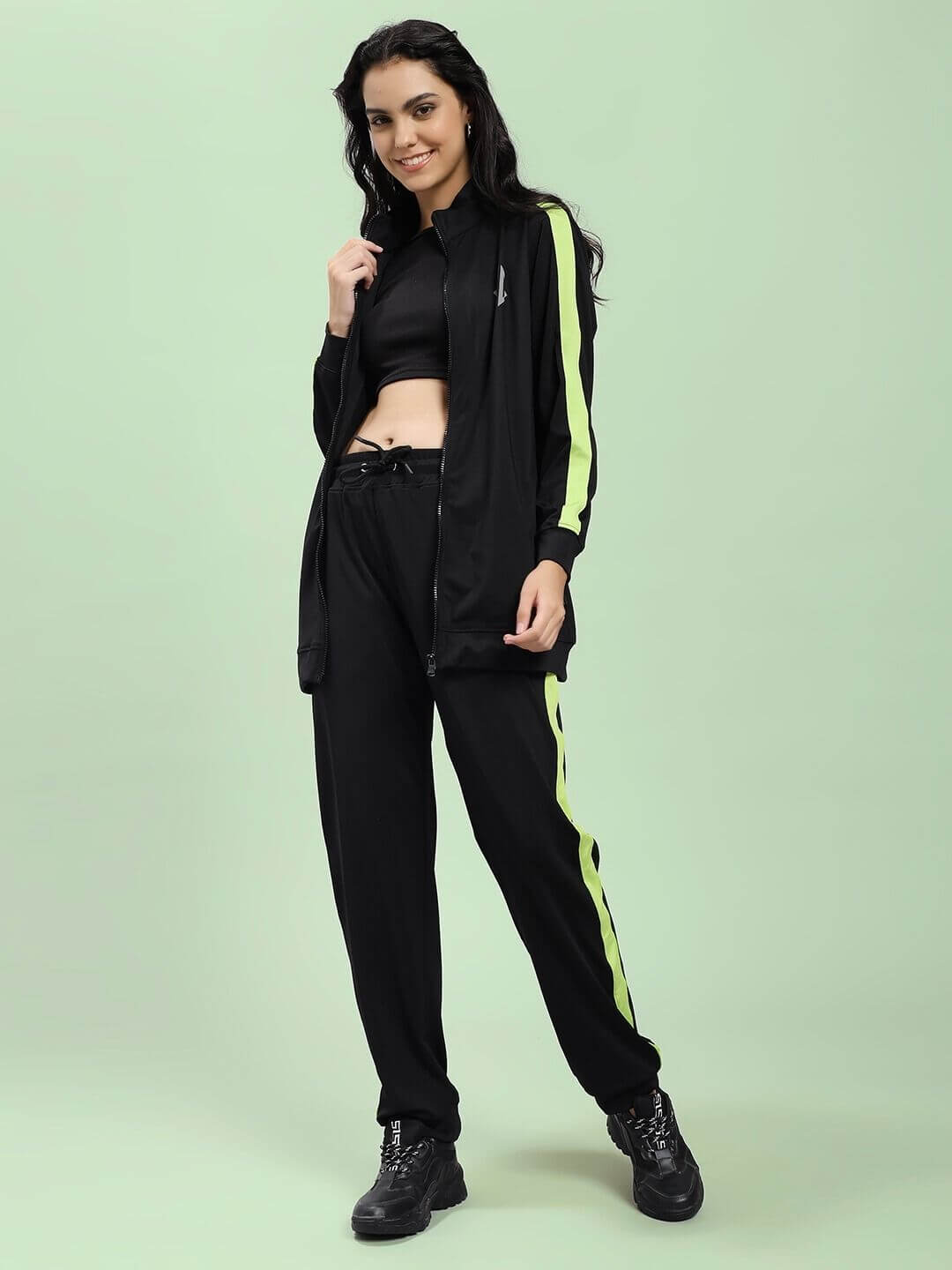 Woman wearing WOMEN HIGH PERFORMANCE CO-ORD SET BLACK with lime stripe design.