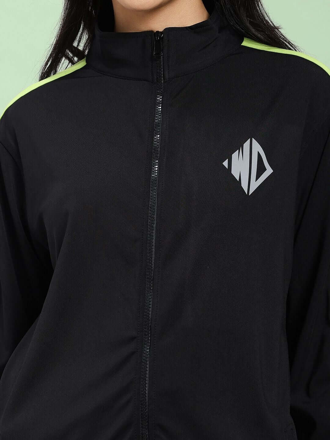 Close-up of WOMEN HIGH PERFORMANCE CO-ORD SET BLACK featuring a zip-up hoodie and logo detail.
