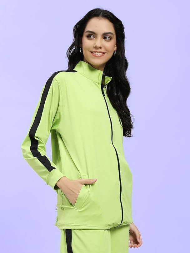 Woman wearing the WOMEN HIGH PERFORMANCE JACKET NEON GREEN, showcasing its bold color and functional design for active lifestyles.