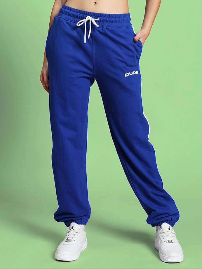 Woman wearing blue high point contrast joggers by DUDS, featuring a casual fit and drawstring waist, perfect for comfort and style.