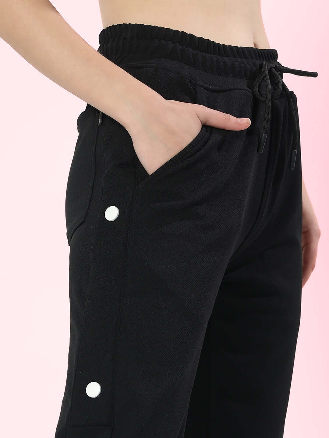 Black women's hip hop joggers with button detailing and elastic waist.