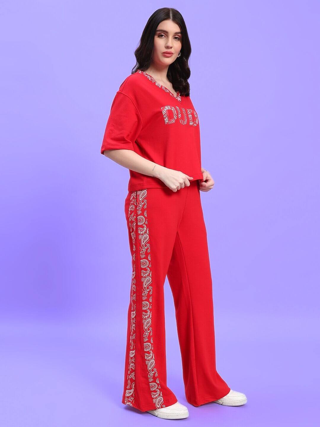 Woman wearing the WOMEN'S HOLLY CO-ORD SET - RED with intricate design, showcasing the vibrant red color and stylish, comfortable fit.