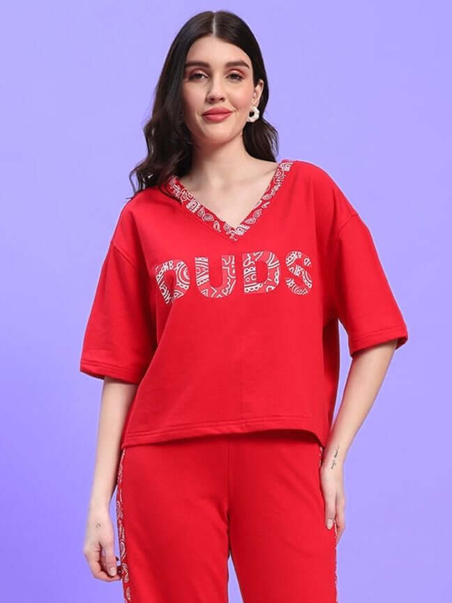 Woman wearing the WOMEN'S HOLLY RELAXED FIT TOP RED from WEAR DUDS, showcasing casual chic style.