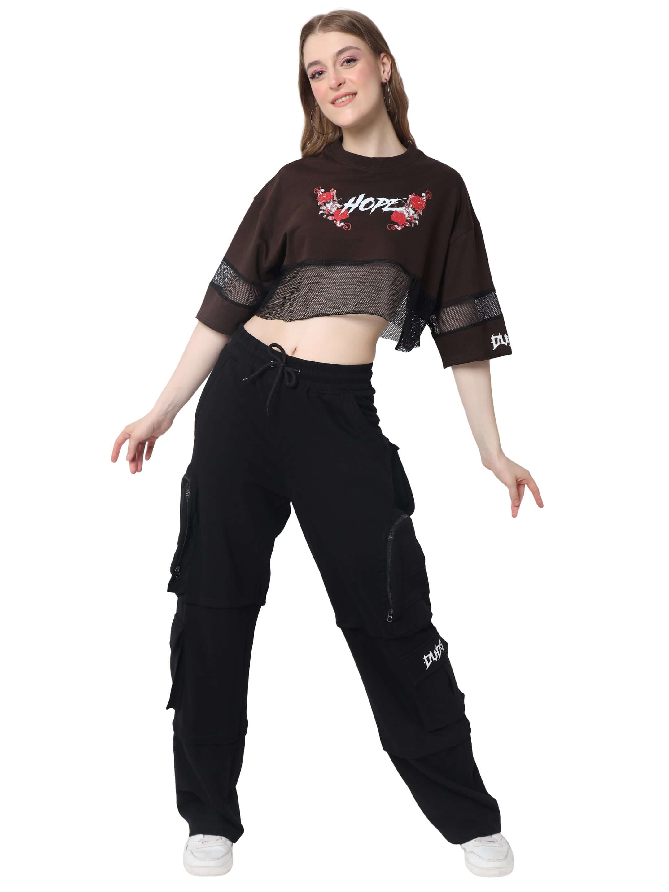 Woman wearing a brown oversized cropped t-shirt with 'Hope' design, paired with black cargo pants, showcasing a casual fashion style.