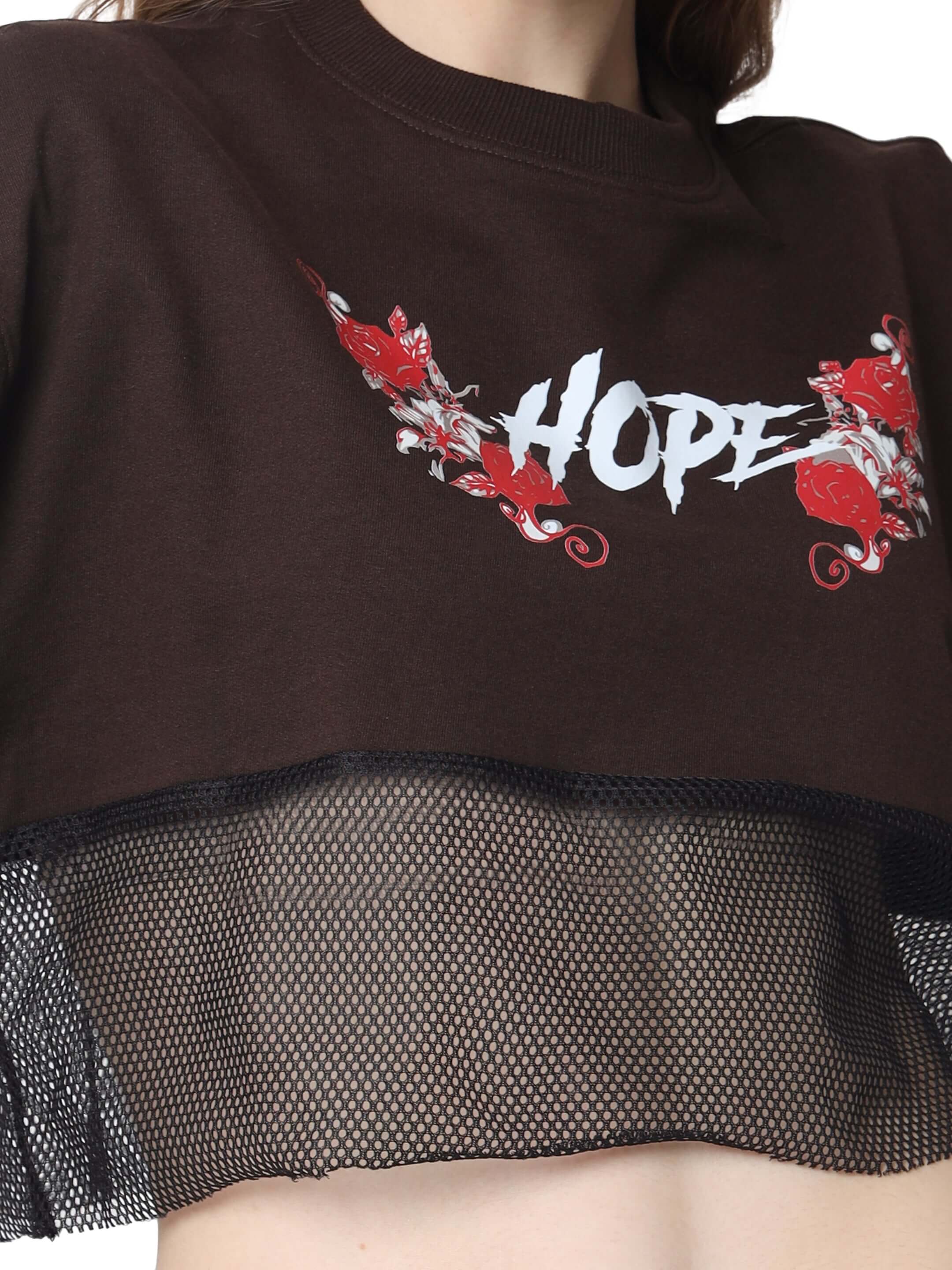 Brown oversized cropped t-shirt featuring 'HOPE' print and red floral design, made of premium cotton French terry and elastane.