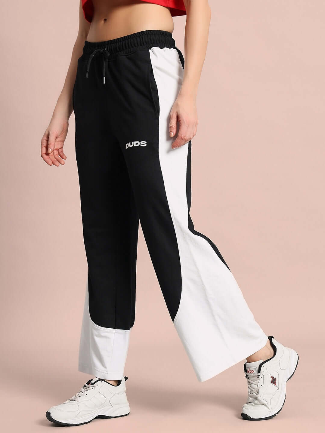 Woman wearing DUDS Women's Hurtle Baggy Joggers in Black and White, featuring a comfortable and stylish fit.