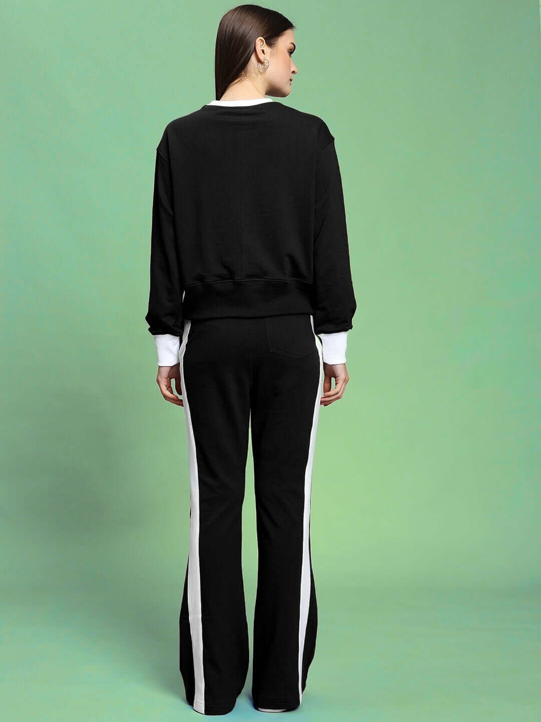 Woman wearing WOMEN'S JESSFLICK RELAXED FIT CO-ORD SET BLACK in back view, showcasing casual style and relaxed fit fashion.