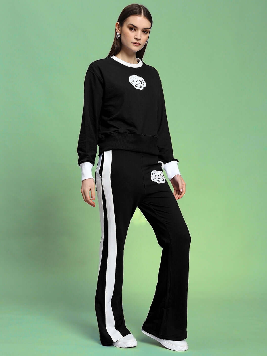 Model wearing WOMEN'S JESSFLICK RELAXED FIT JOGGER in black and white, showcasing comfortable and stylish design.