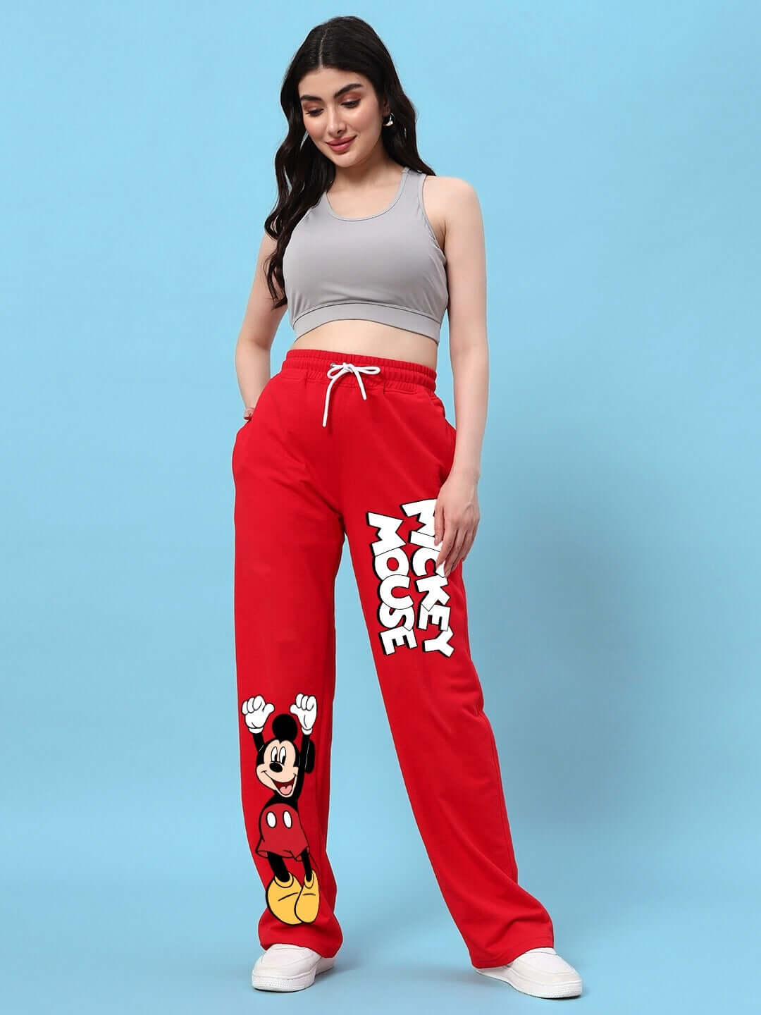 Woman wearing red Mickey Mouse relaxed fit jogger showcasing casual fashion style by DUDS.