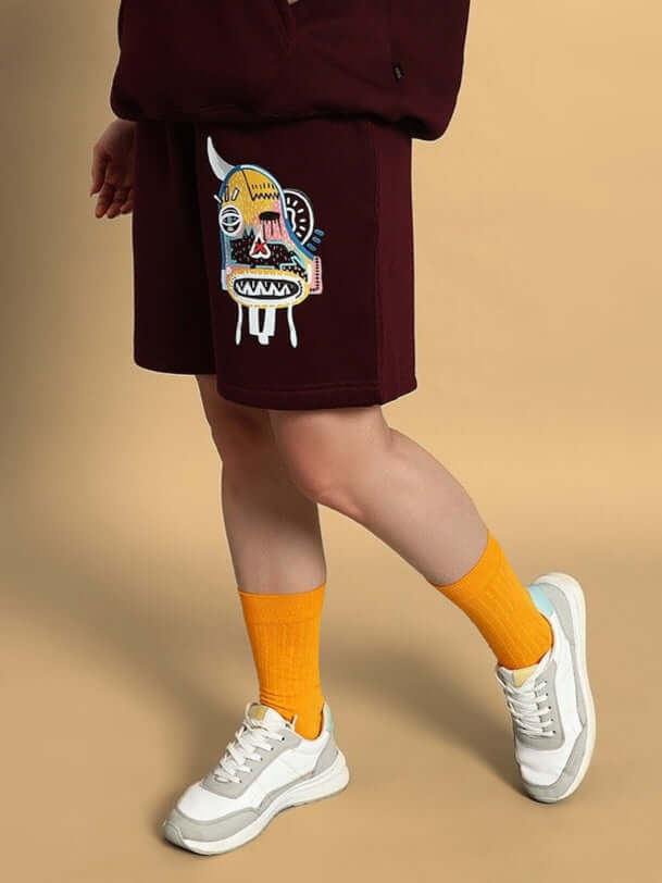 Model wearing Women Jumbled Fleece Shorts Wine by WEAR DUDS, showcasing comfort and chic streetwear style.