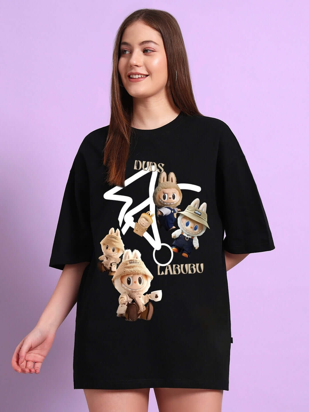 Woman wearing a black oversized T-shirt with LABUBU gang print, made of premium cotton and elastane, perfect for casual wear.