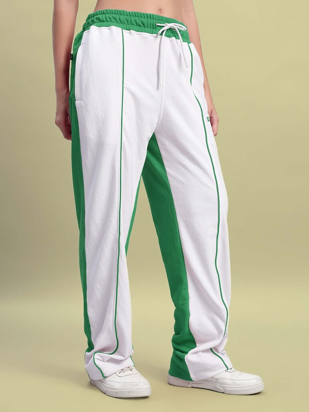 Women's relaxed fit joggers in white and green, made to order with customizable size options by DUDS, shown on model.