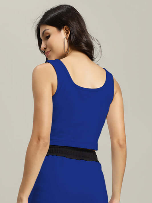 Back view of a woman wearing a royal blue and black Larissa crop-top, crafted from premium heavy gauge cotton fabric.