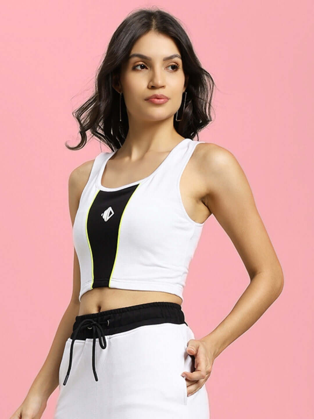 Model wearing women's Larissa crop-top in white and black, made from premium heavy gauge cotton fabric, perfect for casual wear.