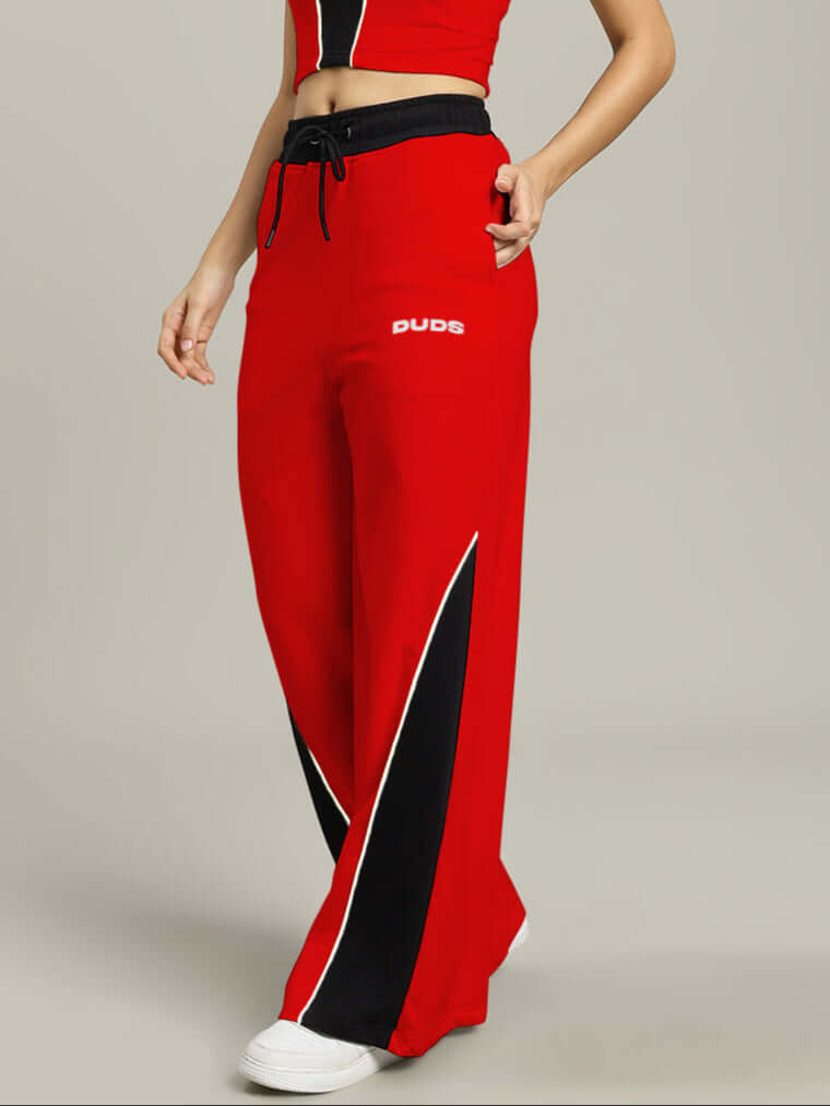 Woman wearing WOMENS LARISSA WIDE ANKLE RELAXED-FIT JOGGERS RED-BLACK with drawstring waist and bold design.