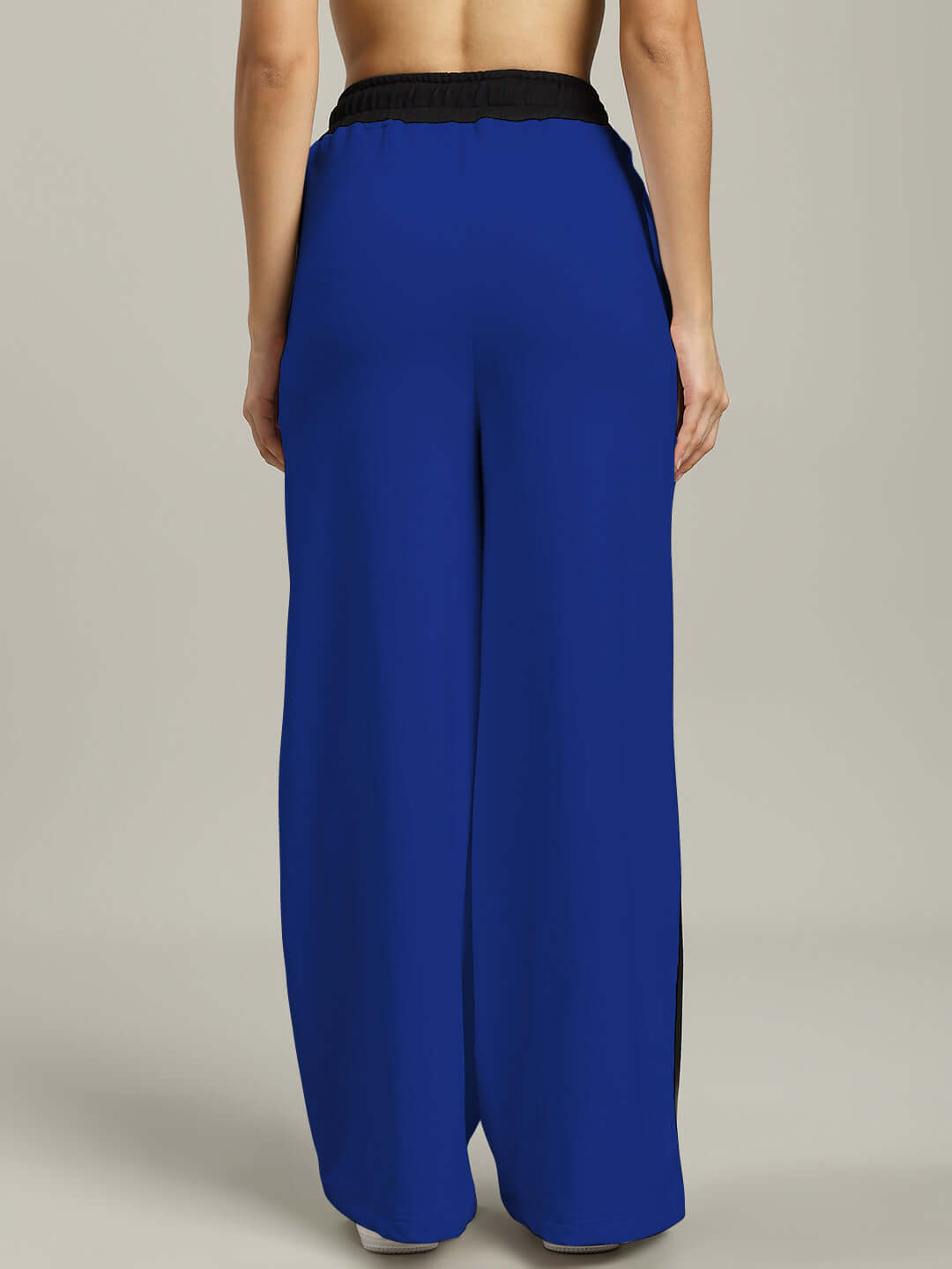 Back view of Women's Larissa Wide Ankle Relaxed-Fit Joggers in royal blue and black, showcasing loose fit and elastic waistband.