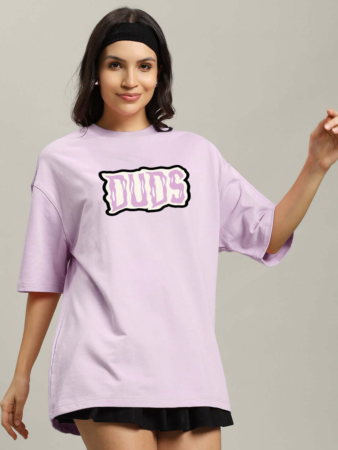 Woman wearing lavender oversized t-shirt with 'Let's Get Spooky' graphic, made from premium cotton, bio-washed for softness.