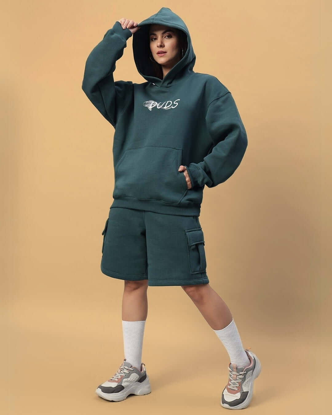 Model wearing WOMEN'S LEOPARD SHARK FLEECE CO-ORD TEAL GREEN, featuring a hoodie and shorts, standing against a neutral background.
