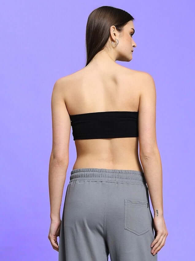 Back view of model wearing WOMEN'S LIA BANDEAU COTTON TOP BLACK showcasing sleek minimalism and timeless elegance.