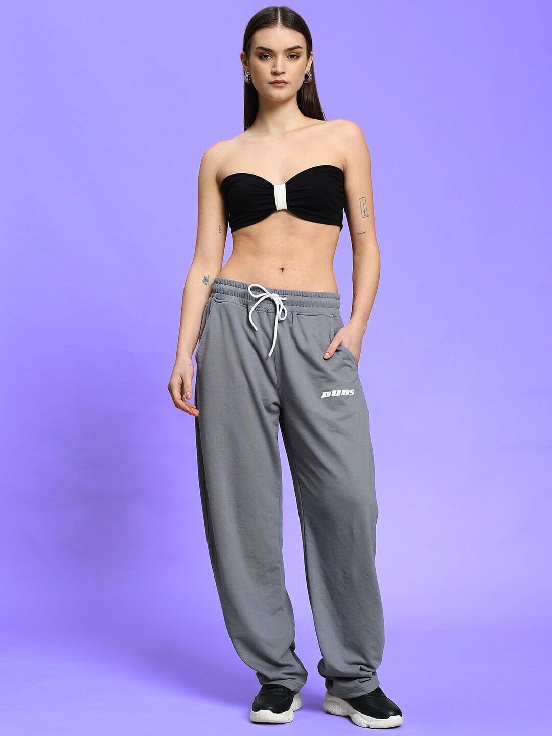 Woman wearing WOMEN'S LIA CO-ORD SET BLACK GREY in a stylish streetwear look against a purple background.