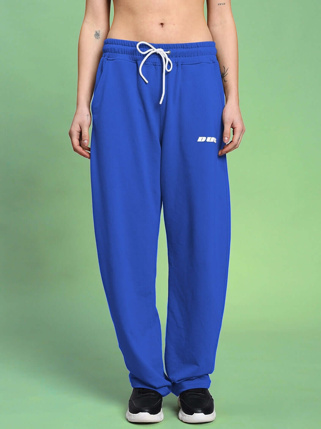 Model wearing WOMEN'S LIA CO-ORD SET BLACK ROYAL BLUE pants from WEAR DUDS, showing modern streetwear style and comfort.