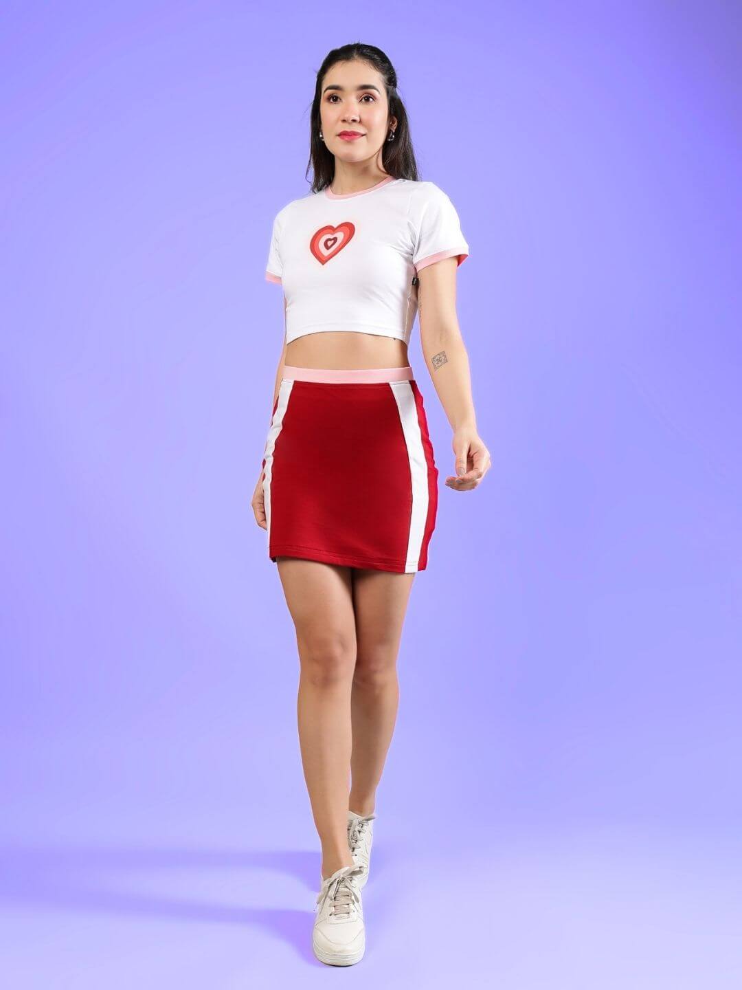 WOMEN'S LIBI HEART ACTIVE CO-ORD SET WHITE-RED modeled on a woman against a purple background, highlighting sporty streetwear style.