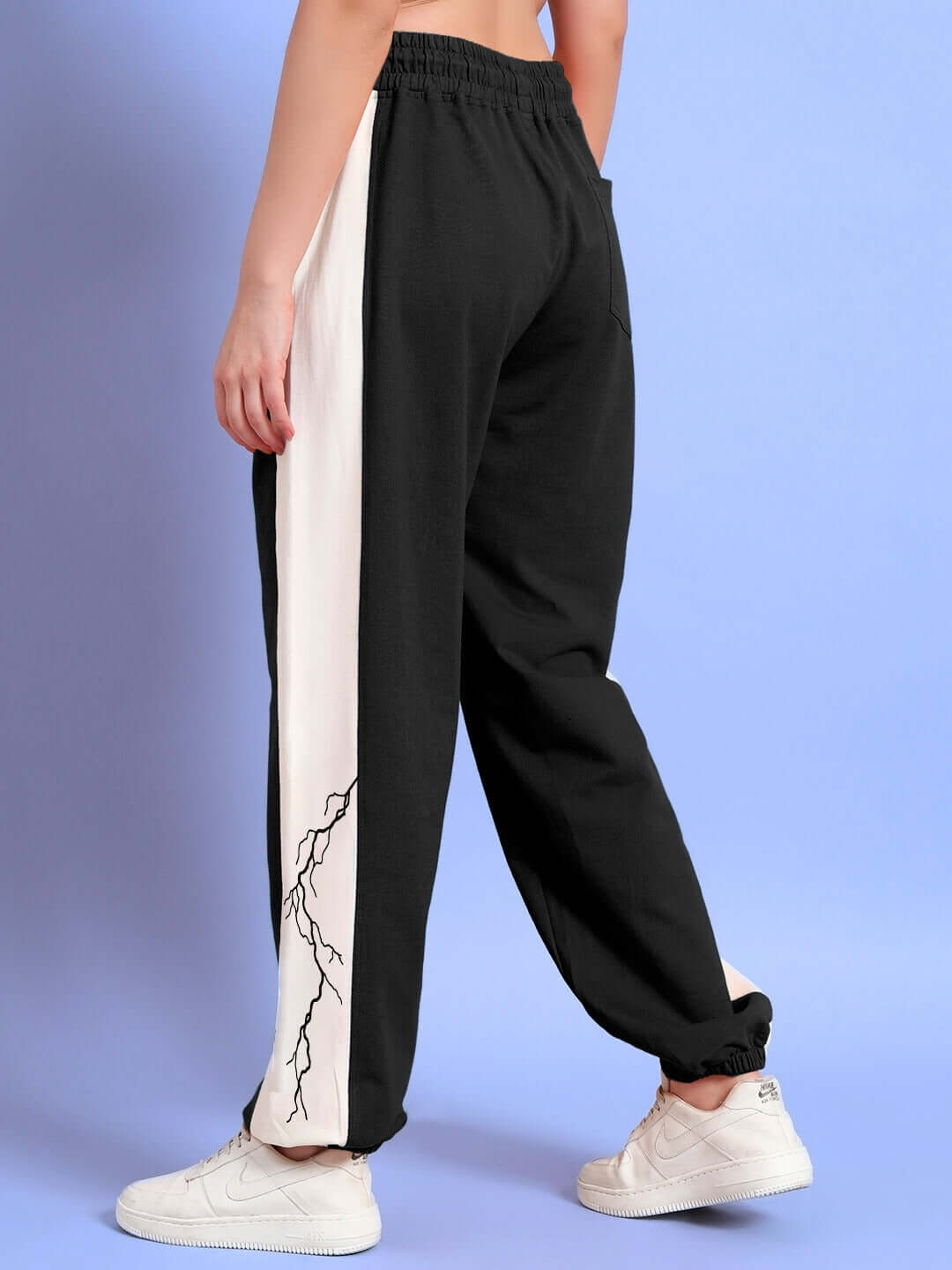 Women's black-white relaxed fit joggers with lightning bolt design, featuring tailored craftsmanship from DUDS.