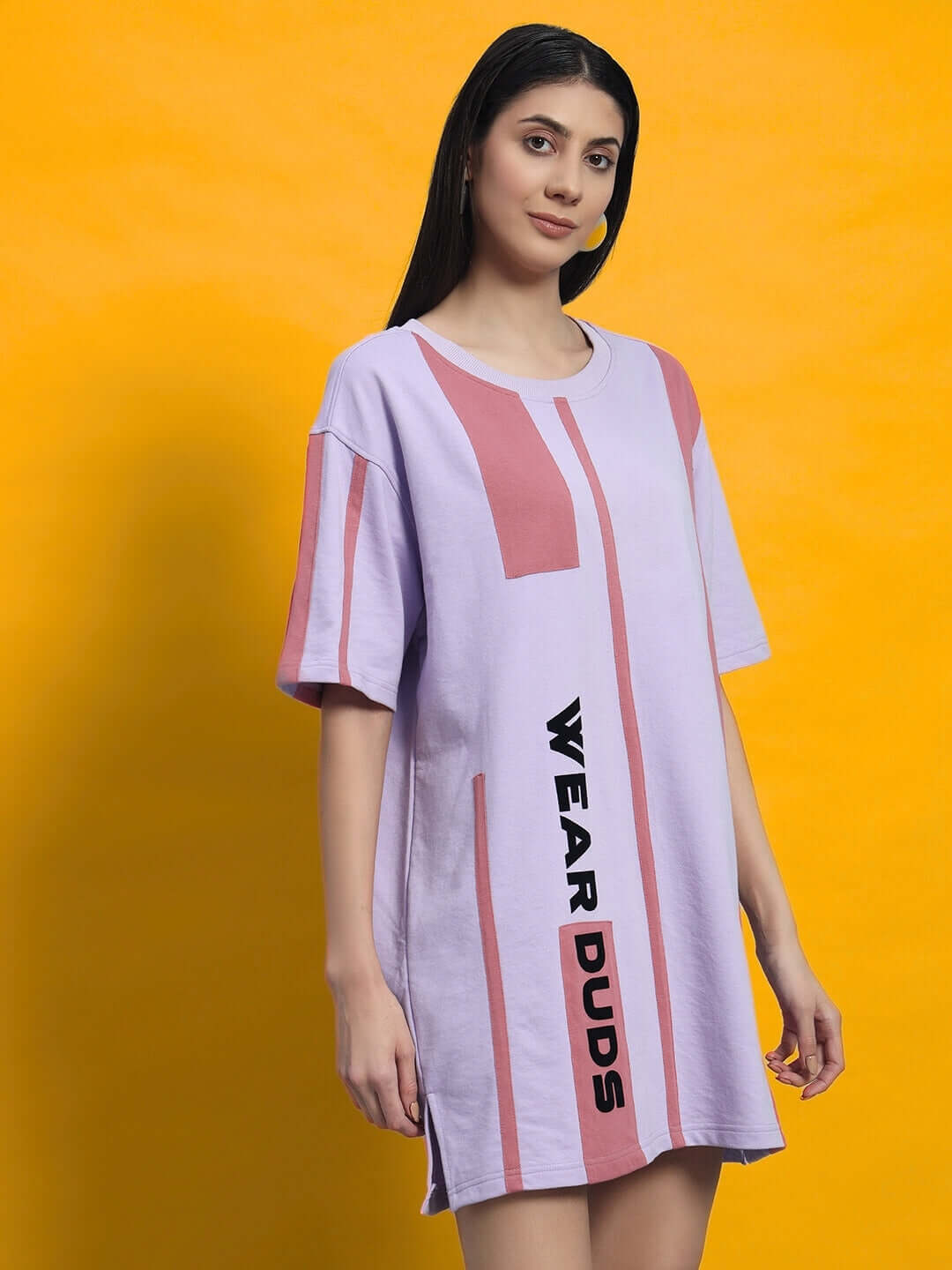 Model wearing a lilac short-sleeved dress with peach puff sleeves and text print. WOMEN'S PEACH PUFF DRESS LILAC for chic style.