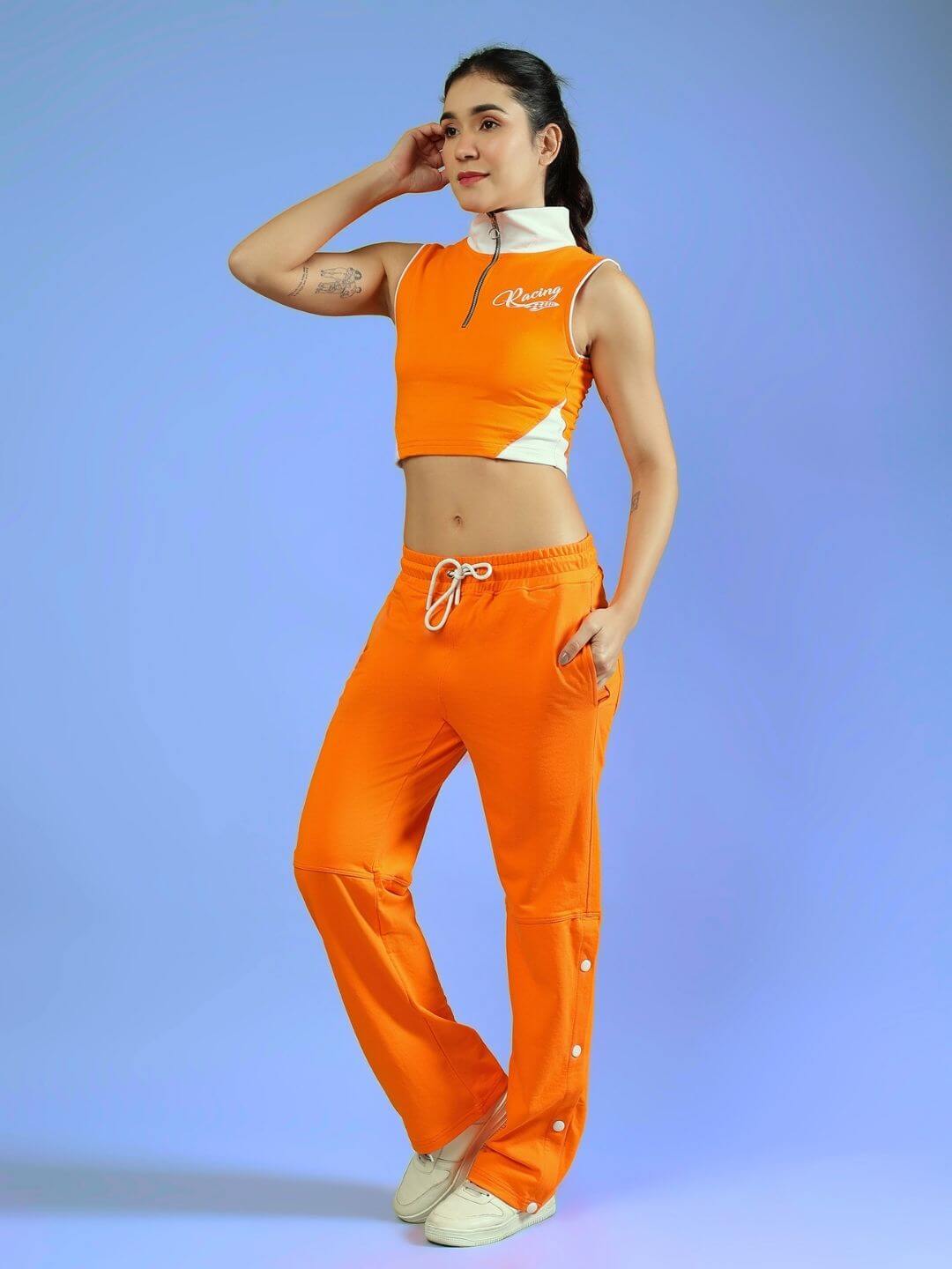 Woman wearing the WOMEN'S LIMA ACTIVE CO-ORD SET ORANGE by WEAR DUDS, showcasing energetic and versatile streetwear fashion.