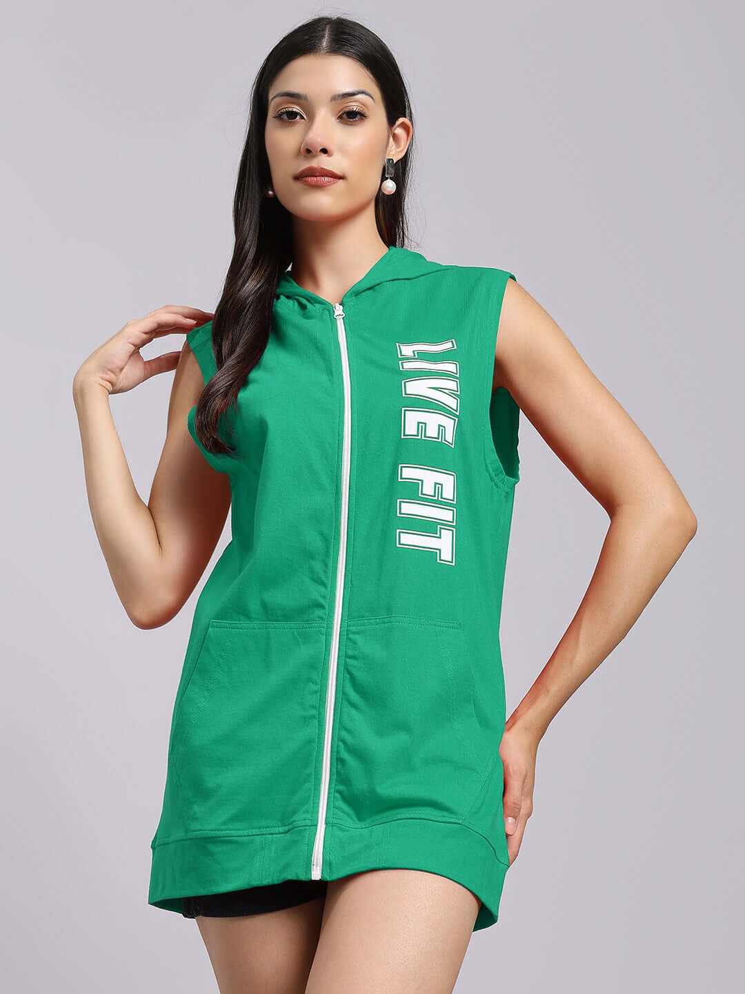 Woman wearing a green WOMEN'S LIVE FIT GYM HOODED T-SHIRT for active style and comfort.