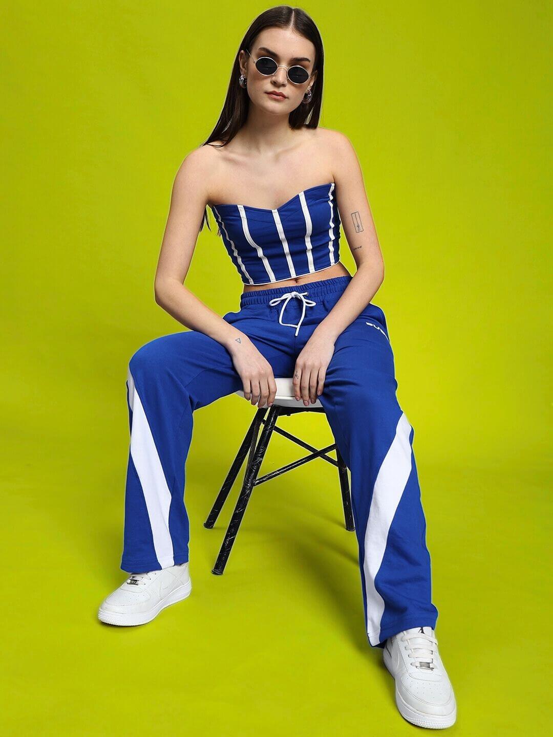 Model wearing WOMEN'S LIVIANA COOL CO-ORD SET BLUE-WHITE from WEAR DUDS against a bright green background, showcasing fashion-forward style.