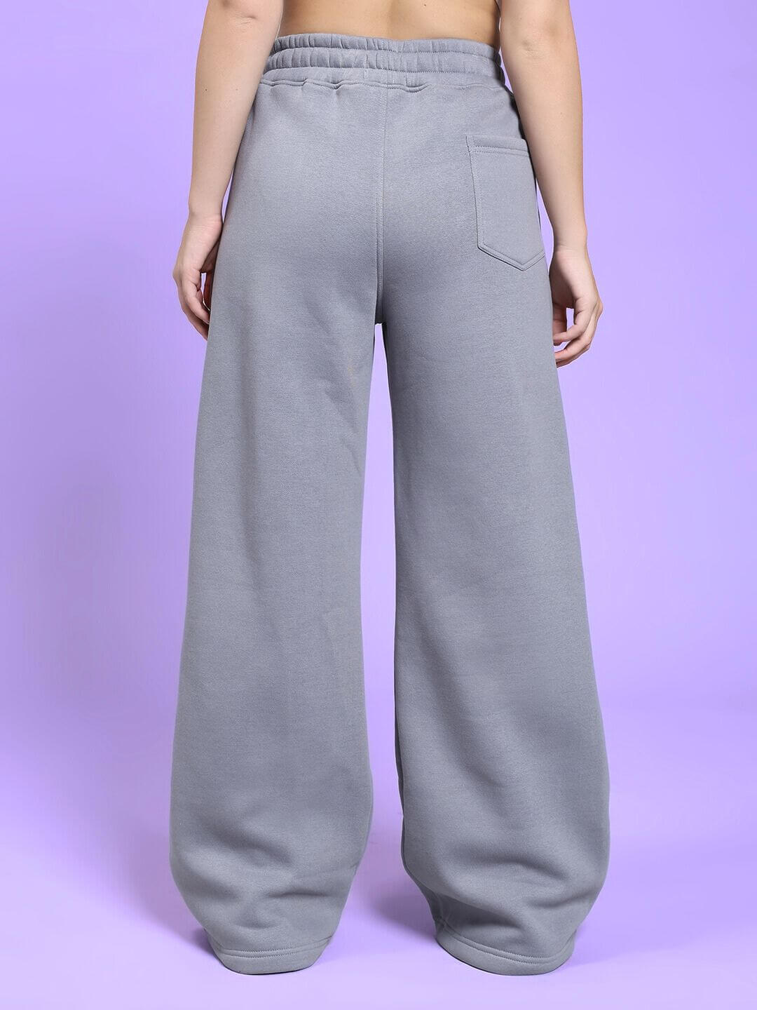 Back view of WOMEN'S MAKE IT HAPPEN COTTON FLEECE JOGGER GREY on purple background.